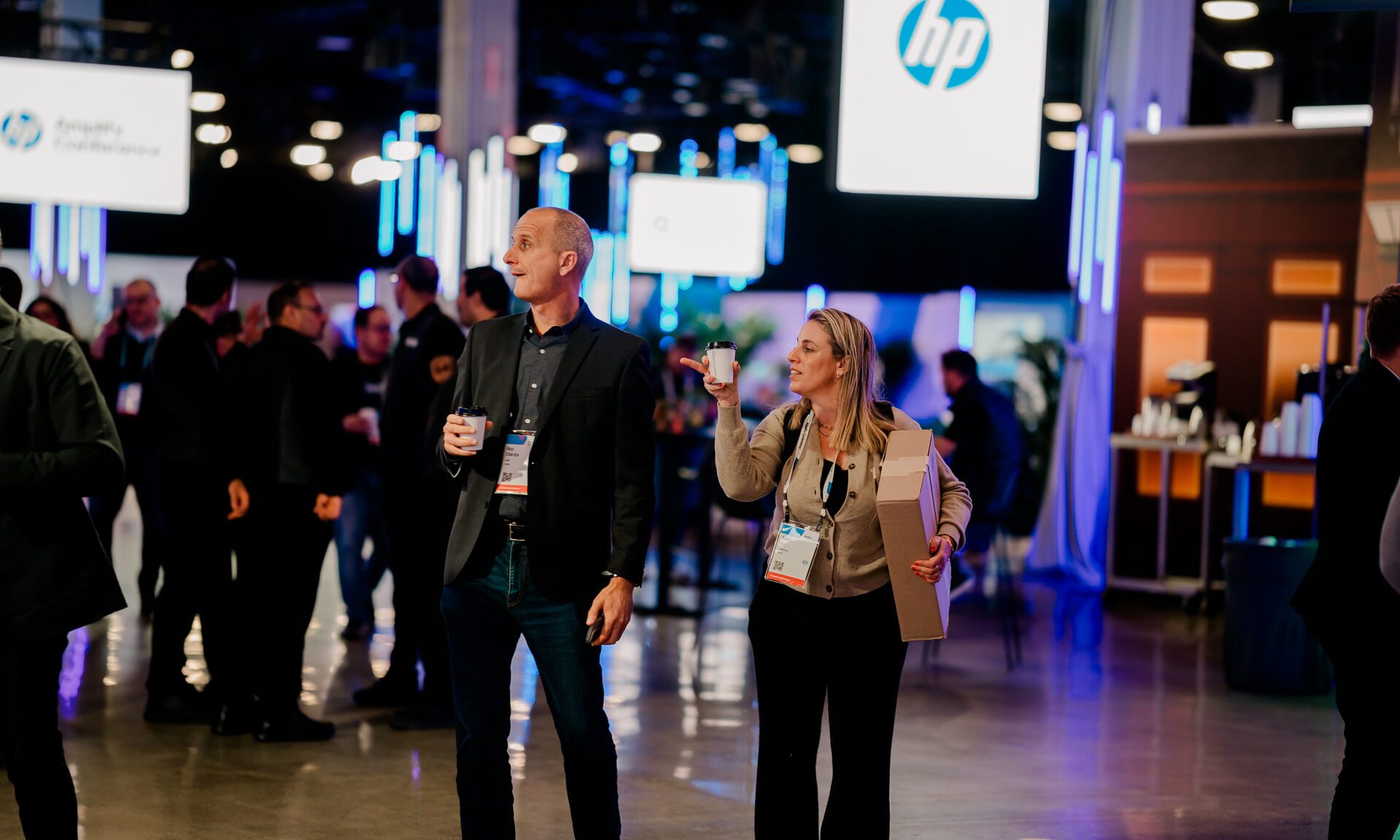 Attendees walking with drinks at hp amplify conference