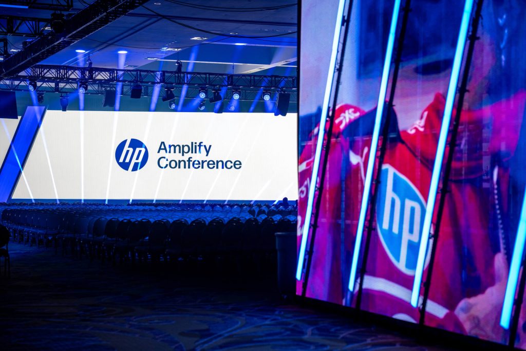 Empty stage with hp amplify conference sign