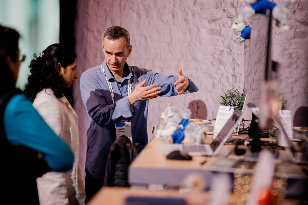 Man explaining technology at booth